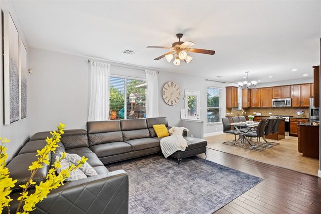 Living room featuring a chandelier, a ceiling fan, light wood-type flooring, and recessed lighting | Image 4