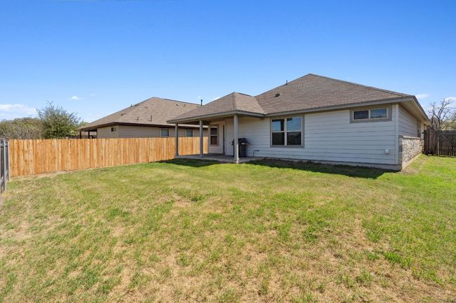 Back of house featuring a covered patio and a recently-installed side fence | Image 32