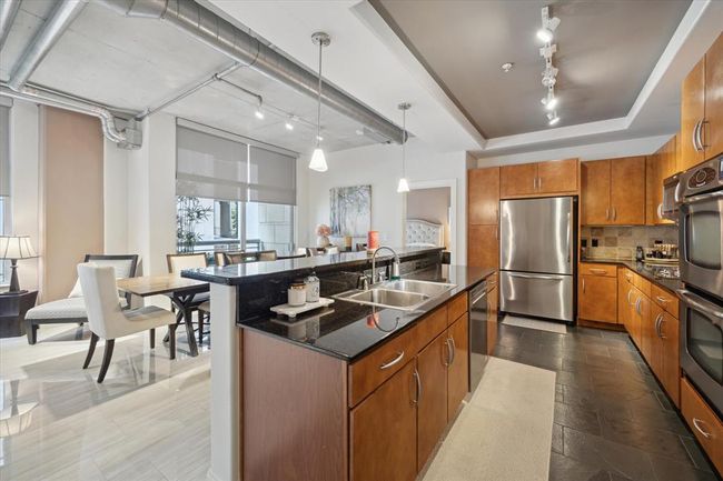 The island kitchen provides an open, functional layout ideal for both accessibility and entertaining. | Image 5