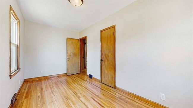 Main level bedroom #1. Refinished hardwood floors and fresh paint. | Image 6