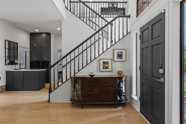 Entrance foyer featuring light wood-style flooring, a towering ceiling, recessed lighting, and stairway | Image 13