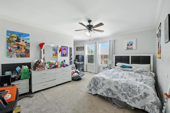 Carpeted bedroom with ornamental molding and a ceiling fan | Image 26