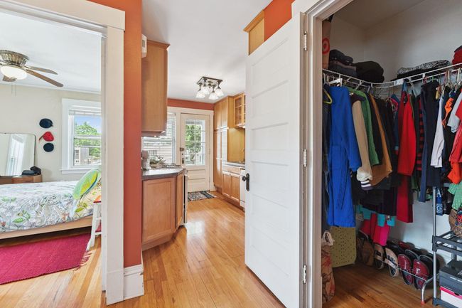 View from hallway into the kitchen. There is a walk in closet on the right and the bathroom on the left. | Image 22