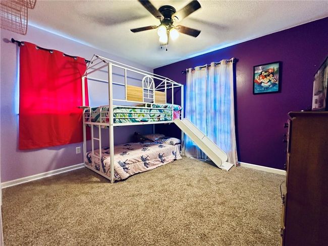 Carpeted bedroom with baseboards, a textured ceiling, and ceiling fan | Image 18
