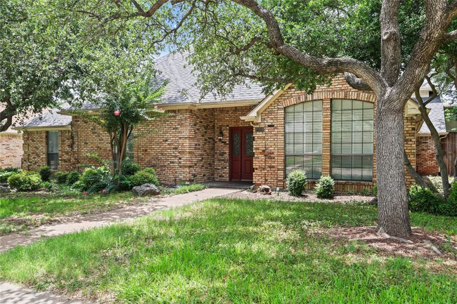 View of front facade featuring brick siding and a shingled roof | Image 5