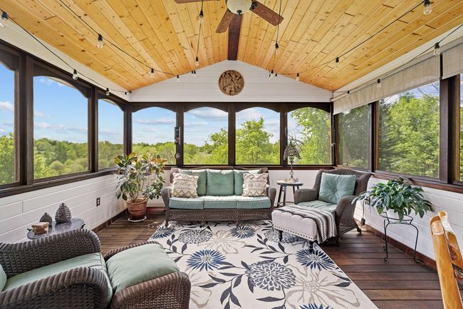 Gorgeous 3 season porch with Ipe wood(Brazillian Walnut)on the floors and adorning the windows. | Image 13