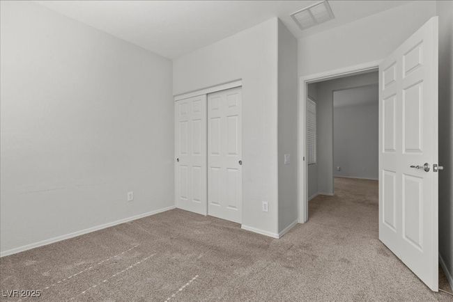 Unfurnished bedroom with carpet flooring and a closet | Image 26