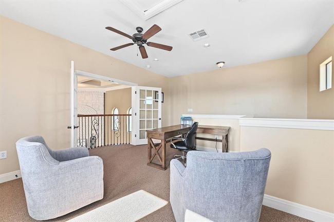 Office space with baseboards, ceiling fan, visible vents, and carpet | Image 18