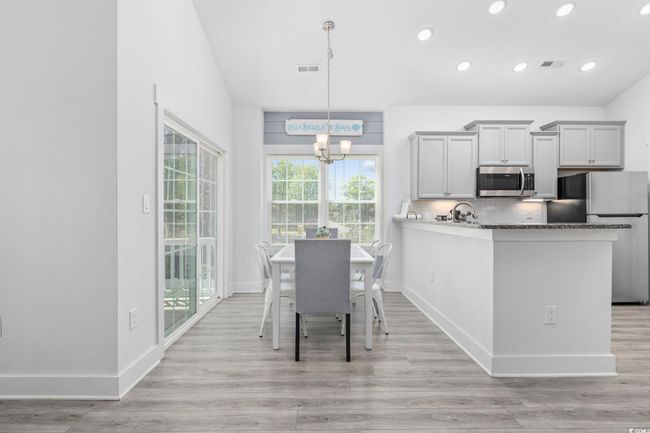 Dining room featuring recessed lighting, light wood-style flooring, visible vents, and a notable chandelier | Image 6