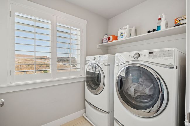 Laundry area with independent washer and dryer and baseboards | Image 27