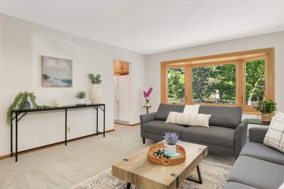 Main floor living room offers a wonderful picture window that overlooks the backyard. | Image 3