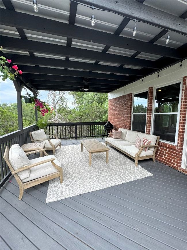Wooden terrace featuring an outdoor living space. | Image 33