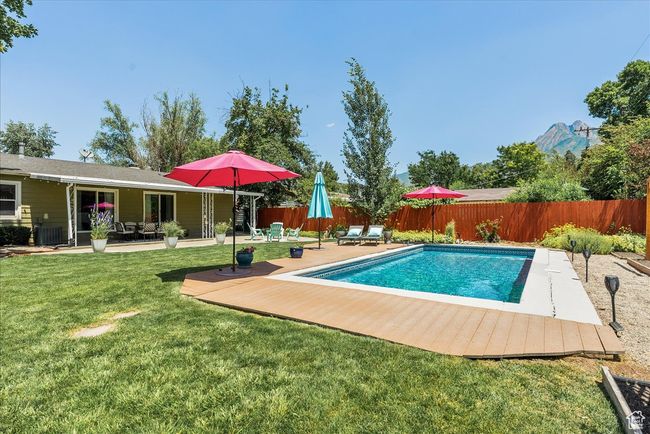 View of pool featuring a fenced backyard and a patio | Image 47