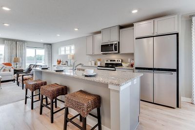 The centerpiece of this home is the beautifully appointed kitchen and 9-foot center island! Model home, details will vary. | Image 1