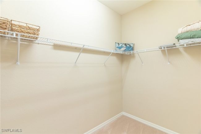 Walk in closet with light carpet | Image 17