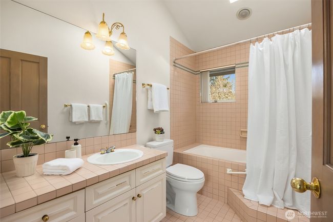 Second full bathroom upstairs features a skylight. | Image 33