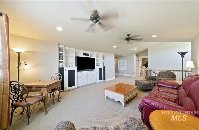 Living room featuring a ceiling fan, light carpet, lofted ceiling, and recessed lighting | Image 31