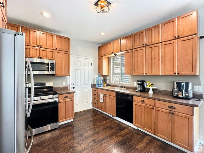 Kitchen with stainless steel appliances, sink, and dark wood-type flooring | Image 5