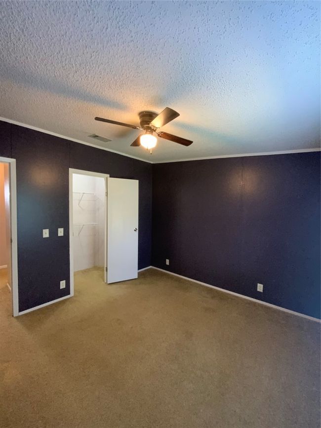 Unfurnished bedroom featuring visible vents, carpet, a closet, and a walk in closet | Image 29