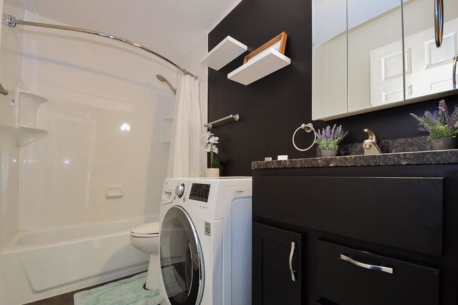 Euro style washer/dryer combo in bathroom. | Image 16