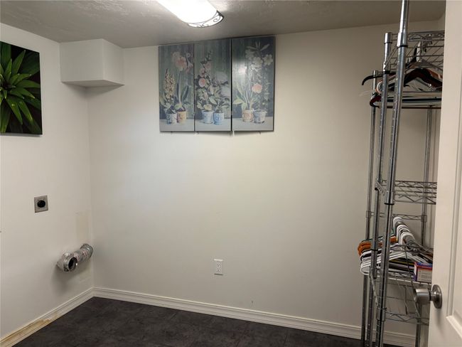 Clothes washing area featuring hookup for an electric dryer and baseboards | Image 18
