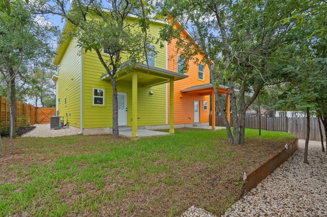 View of front facade with central air condition unit, a fenced backyard, and a front yard | Image 26