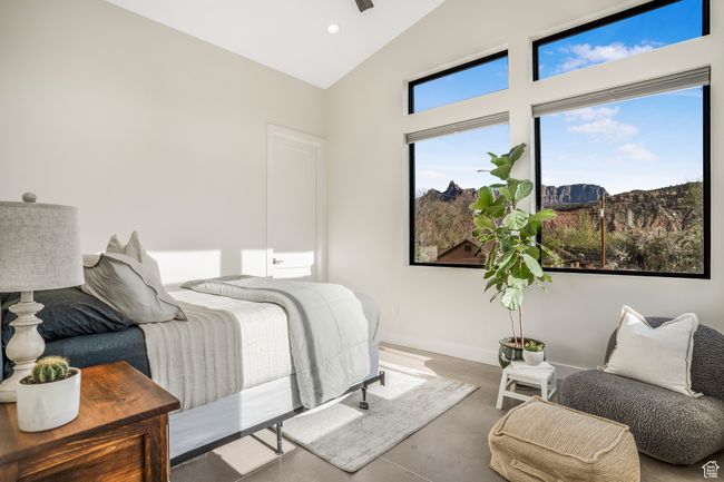 Bedroom with baseboards, a mountain view, recessed lighting, high vaulted ceiling, and finished concrete floors | Image 33