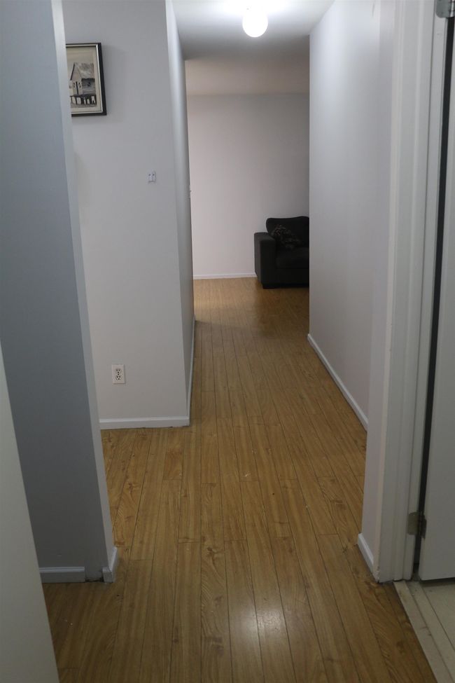 Hallway with hardwood / wood-style flooring and baseboards | Image 7