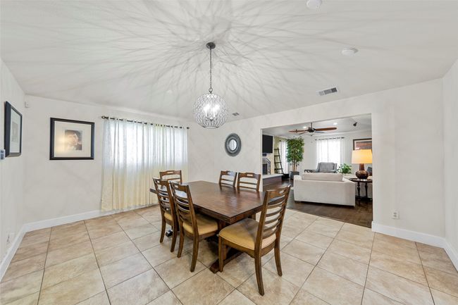 Dining space with light tile patterned flooring, visible vents, and baseboards | Image 23