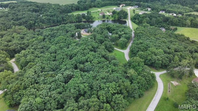 Aerial view of property and surrounding area with a nearby body of water and a forest | Image 5