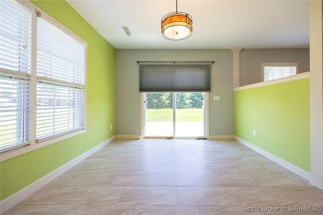 Dining area. Custom shade on door to patio | Image 58