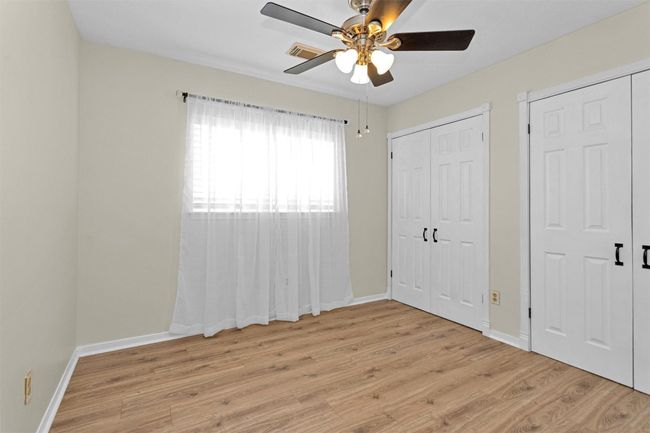 One of the secondary bedrooms is show here. Note the two double doors that enter into the pass through closet for ample storage. | Image 21