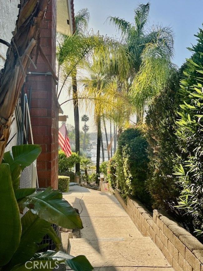 View of side of house walking leads to patio | Image 43
