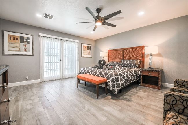 Bedroom featuring baseboards, wood finished floors, access to exterior, and ceiling fan | Image 39