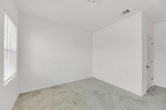 Soft, plush carpet flooring adds comfort and warmth to the guest bedrooms, ensuring a cozy retreat. | Image 19