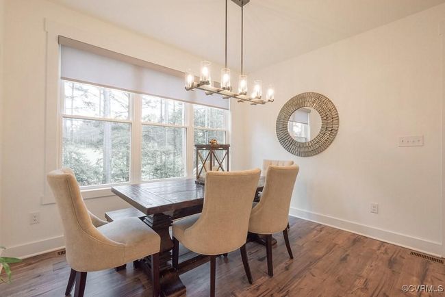 Dining area featuring a chandelier and wood finished floors | Image 33