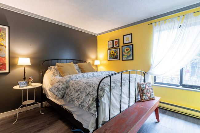 Bedroom with a baseboard radiator, wood finished floors, baseboards, and ornamental molding | Image 20