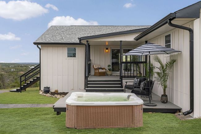Rear view of house with a yard and hot tub | Image 34