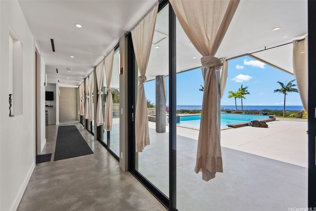 View of hallway on lower floor. Fleetwood sliding glass doors. | Image 14