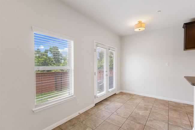 Unfurnished dining area featuring light tile patterned floors and french doors | Image 15