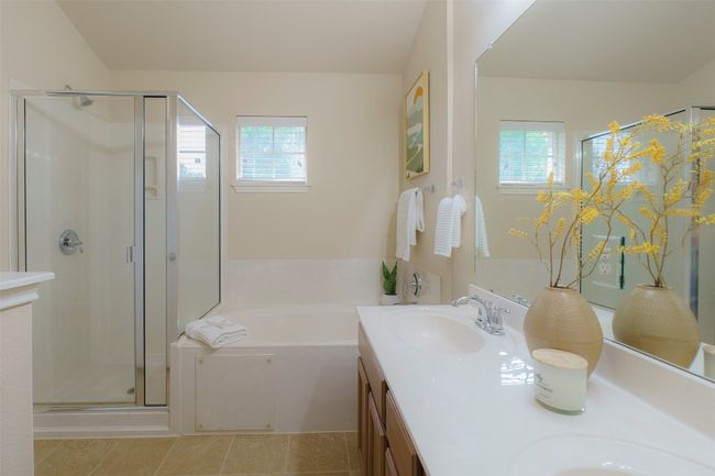 Full bath featuring a shower stall, plenty of natural light, a garden tub, and a sink | Image 13