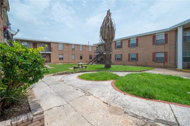 View of property's community with a lawn and stairs | Image 11