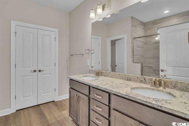 Full bathroom featuring double vanity and tile shower | Image 8