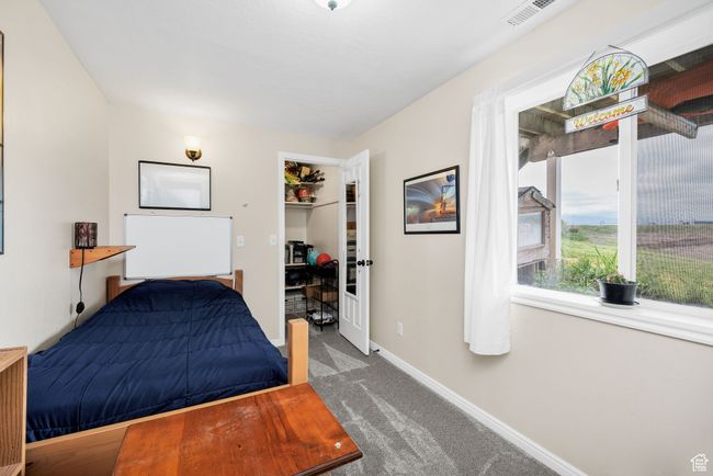 Basement Carpeted bedroom with baseboards, a closet, and a spacious closet | Image 23