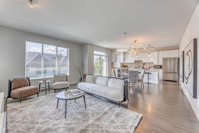 Living room with a chandelier and light wood-style floors | Image 5