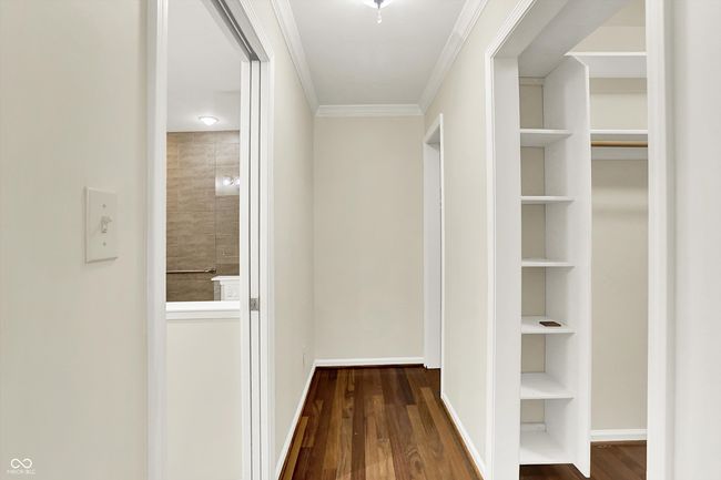 Hall leads to primary bathroom and TWO walk-in closets | Image 34