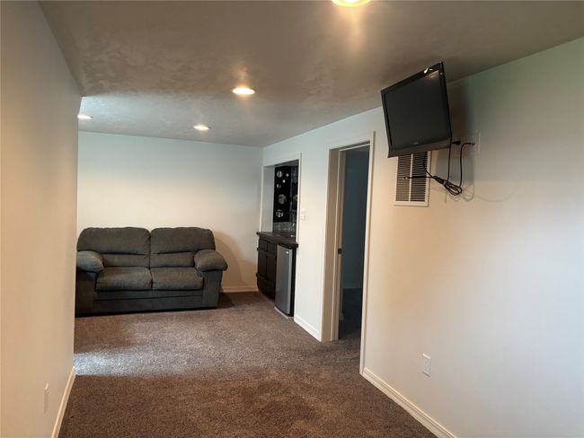 Living room featuring dark colored carpet, baseboards, and recessed lighting | Image 19