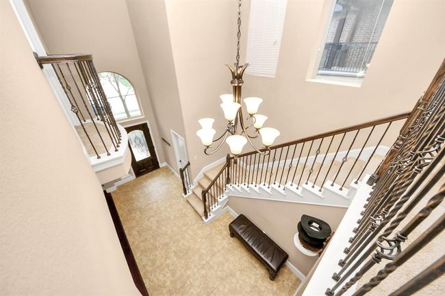 The view from upstairs shows how elegant the front foyer is, and notice the Juliet balcony off of the Upstairs Office! | Image 19