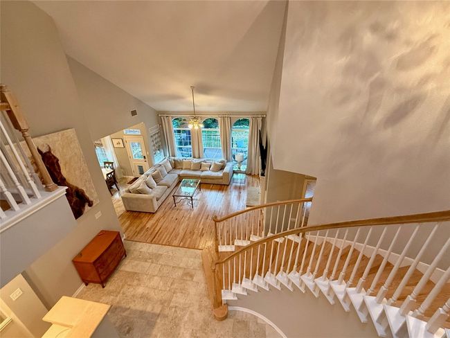 Living room with stairway, high vaulted ceiling, and light wood finished floors | Image 20