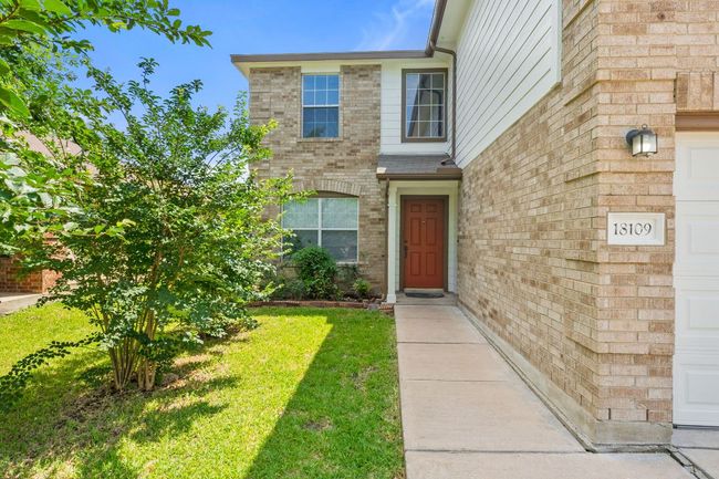 Doorway to property with brick siding and a lawn | Image 4